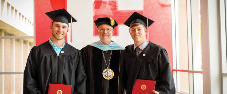 President Mark Putnam posing with Central College's first Engineering graduates.